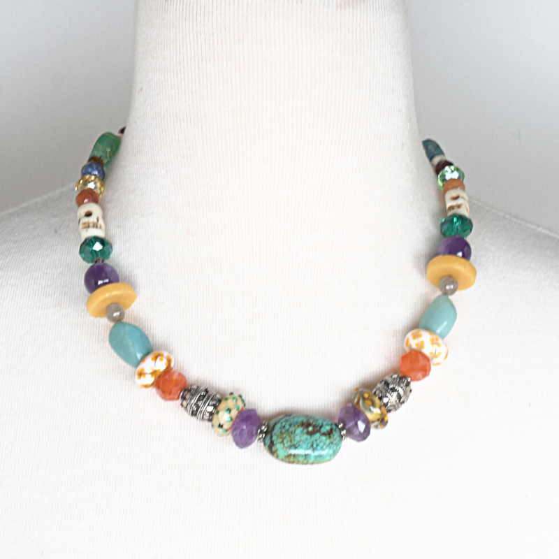 Colourful beaded necklace with turquoise, amethyst, carnelian, Lapis lazuli, and rose quartz stones, and beads made from bone, crystal, sterling silver, flame-worked and recycled glass. Designed and handcrafted by Ula Frou creator Sadie Hodson on Salt Spring Island.
